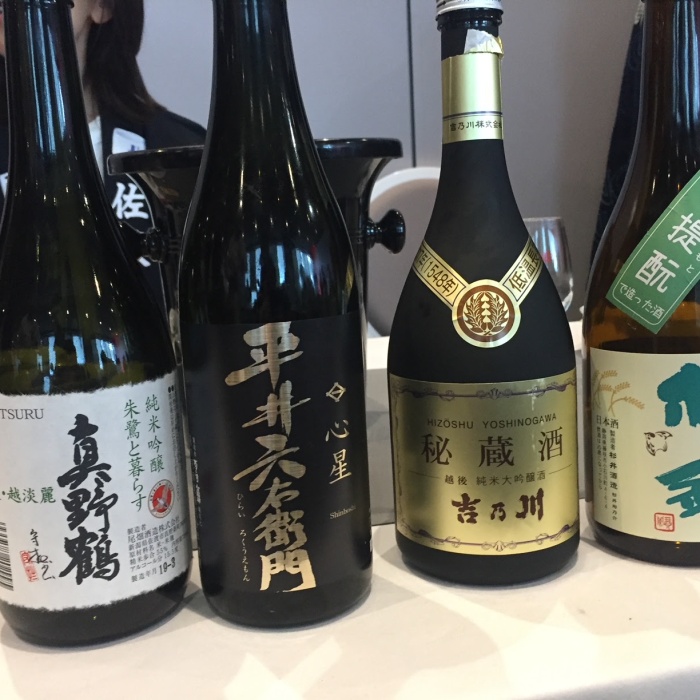 Selection of four sake bottles on a table