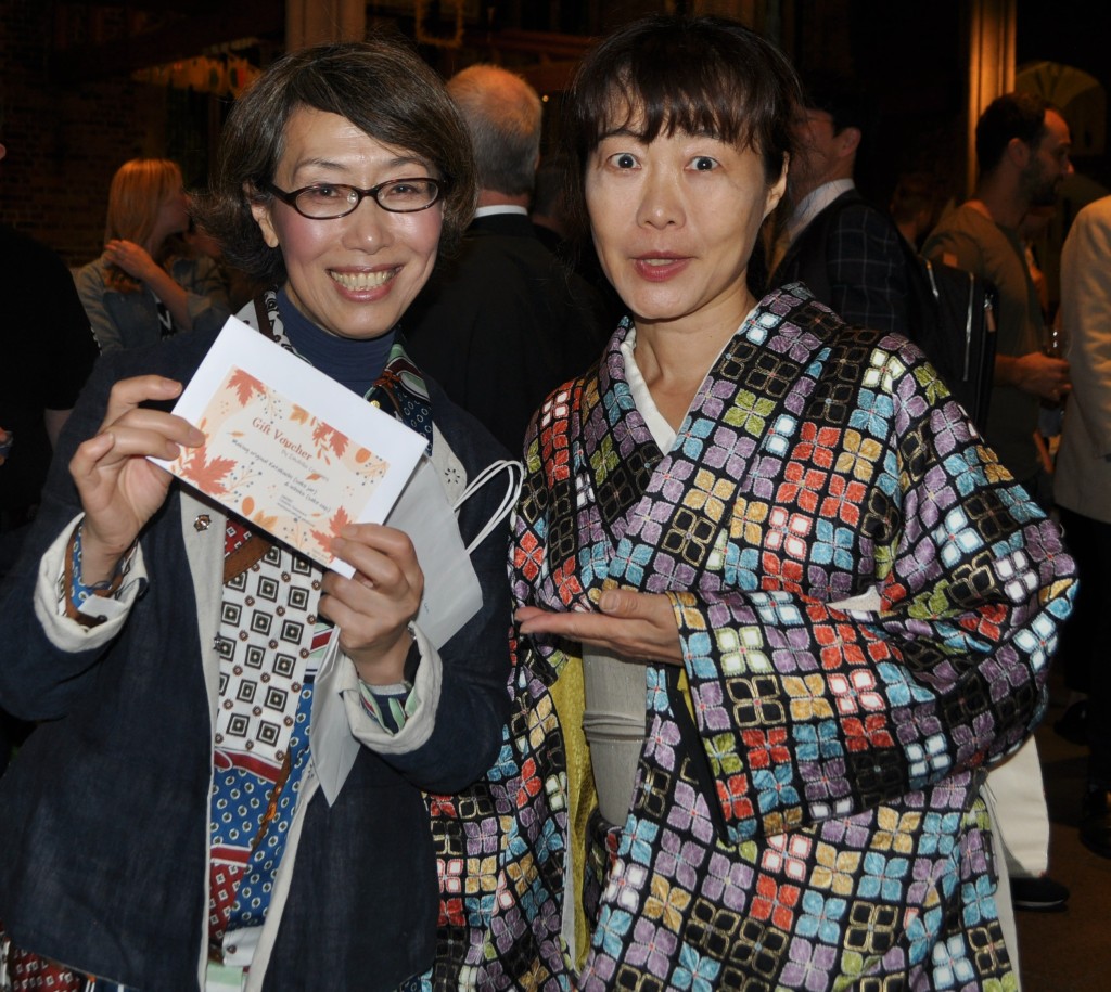 2022 Grand Tasting of Sake - Akemi Yokoyama holding a gift voucher, with Imahiko Kawamura